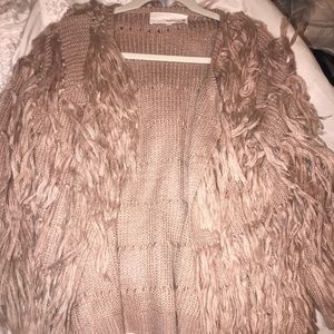 A light pink/purple fluffy cardigan